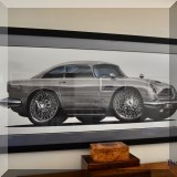 A39. Large framed cutout print of an Aston Martin DB5. (James Bond's car) Frame: 29”h x 60”w 